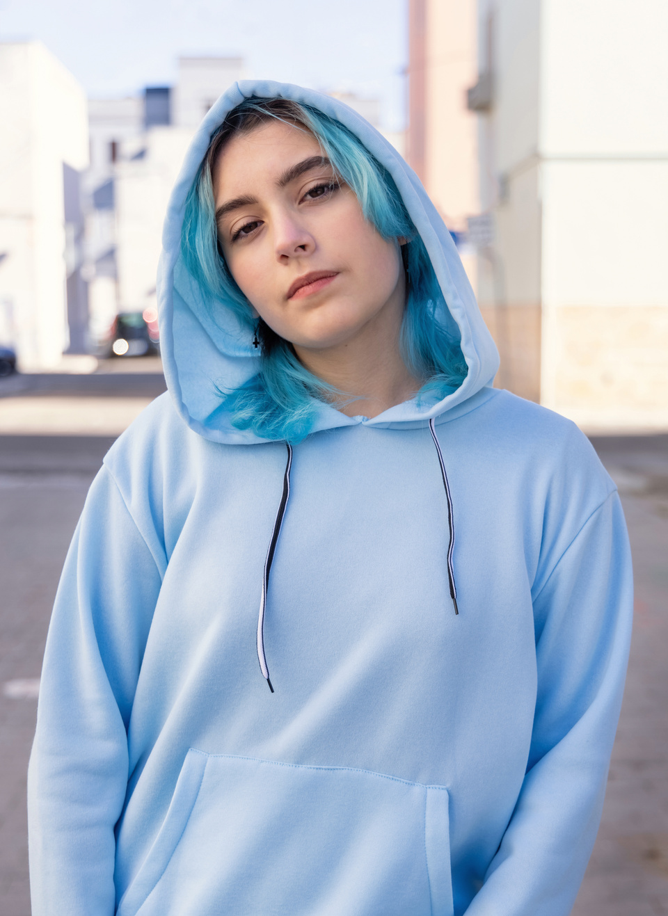 Blue Haired Teenage Girl in Light Blue Oversize Hoodie Stays Out