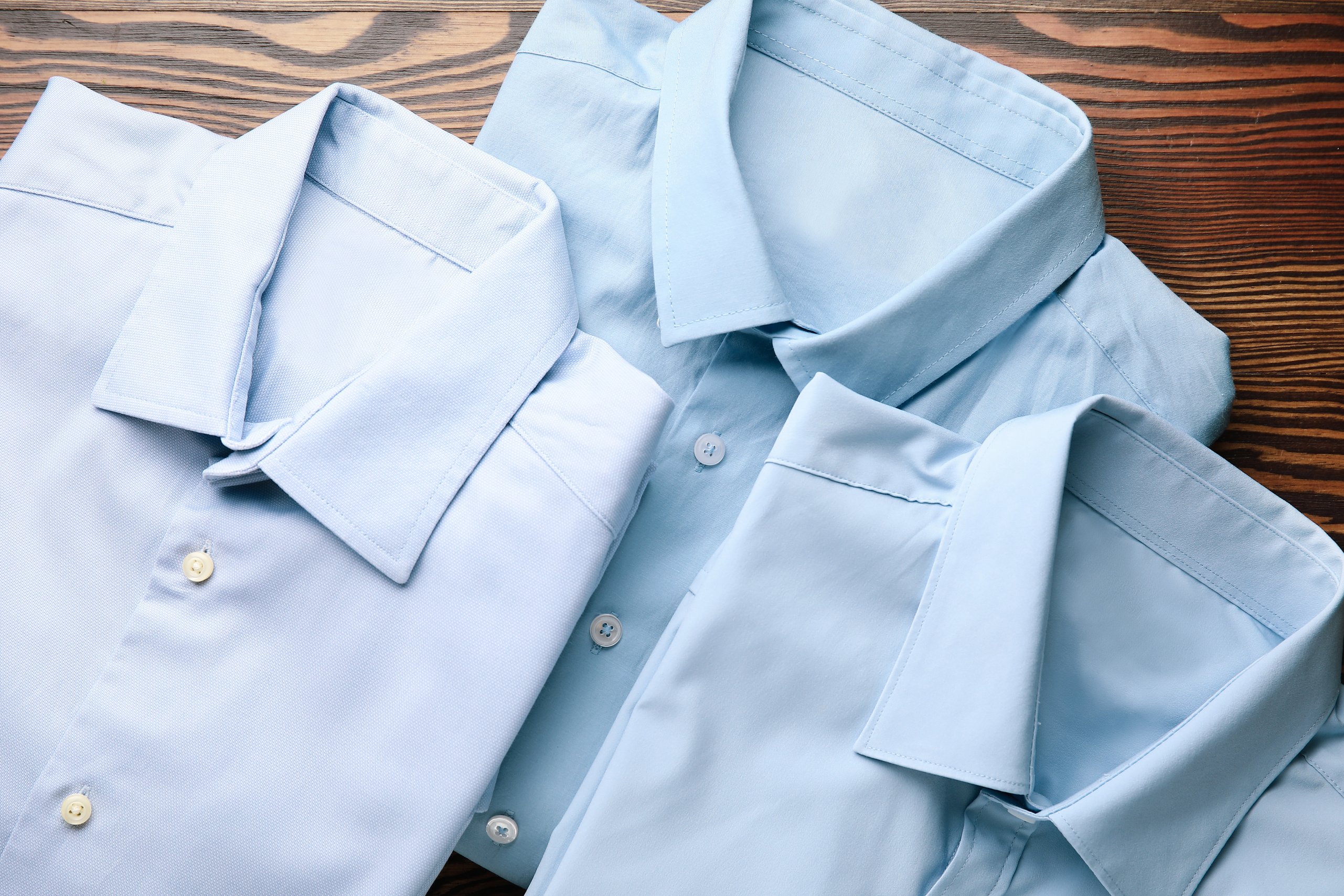 Clean and Folded Formal Shirts on a Wooden Table