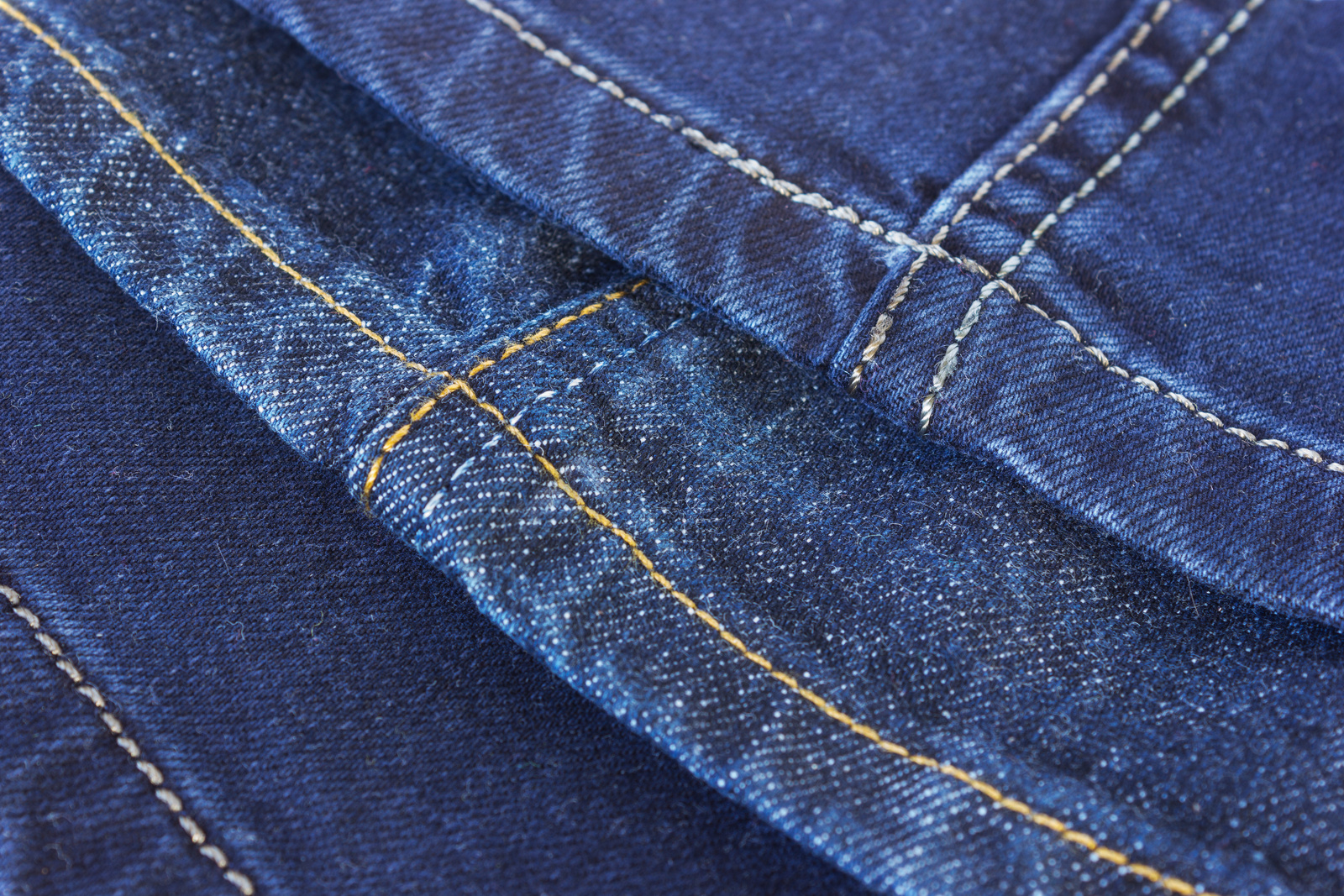 Seams on blue denim trousers
